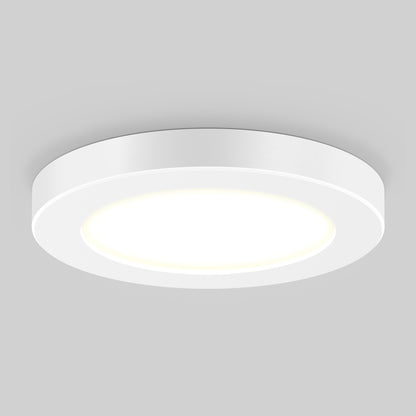 The 5" LED Skylight with 3 colour trim rings is a round, white, flush-mounted ceiling fixture with a smooth modern design, casting a soft, bright glow against a light gray background.