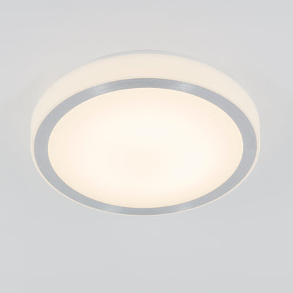 The StarRaker LED Flush Mount Light features a round, modern design with a frosted white cover and metallic silver rim, mounted on a white ceiling and emitting a soft, diffused glow.