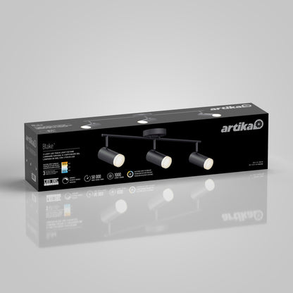 Black rectangular box packaging for the 32" Blake 3L tracklight by Artika features an image of the LED fixture with three adjustable spotlights and product details on the front, with the box reflected on a light gray surface.