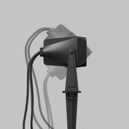 The Verner - Solar Landscape Single CCT LED 4-pack features sleek black spotlights with cords, adjustable stands, and modern design. Displayed against a gray background, the lights are positioned in various angles to suggest movement.