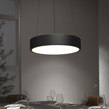 The Concerto LED Pendant, a modern black light fixture, hangs above a dining table set with empty wine glasses and plates in a softly lit, contemporary dining room.