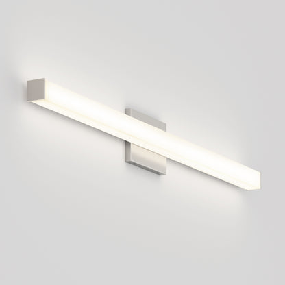 The Mylo LED Vanity Light 36IN is a modern wall-mounted fixture with a long rectangular frosted white cover and metallic ends, emitting a soft, even glow against a plain white wall.