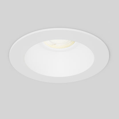 The Skyview 4in Regressed Round, 5CCT LED is a white, circular recessed ceiling light with adjustable color temperature, shown switched on and emitting bright light through its diffuser against a plain light gray ceiling.
