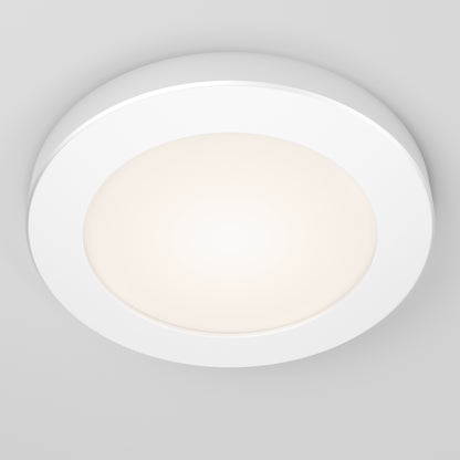 The Skylight Pro 5 3K LED Flat Panel Light is a round, white ceiling fixture with a frosted center that emits a soft, even glow when mounted on a smooth, light-colored ceiling.