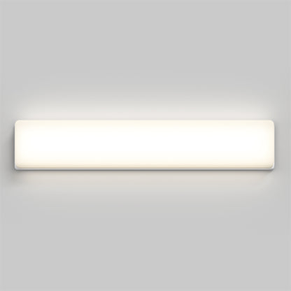 The Aster 27in Energy Star LED Vanity Light is a modern, rectangular wall-mounted fixture that emits a soft, even glow against a plain light gray wall.