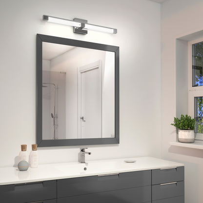 Modern bathroom with a large square mirror above a sleek gray vanity, featuring the Tivoli 27'' Vanity Light above the mirror, a white sink, toiletries, and a potted plant on the windowsill. The door and shower are reflected in the mirror.