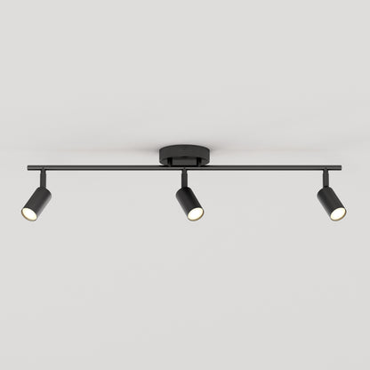 The 32" Rowen 3L tracklight is a modern black ceiling fixture featuring three adjustable cylindrical spotlights on a horizontal bar, each angled differently against a plain white ceiling.