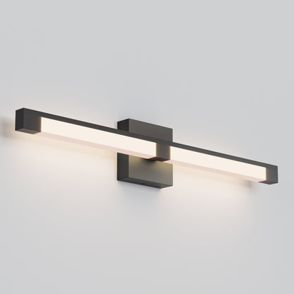 The Tivoli 27'' Vanity Light is a modern wall-mounted LED fixture with a sleek rectangular design and black frame, casting soft white light against a plain, light-colored wall.