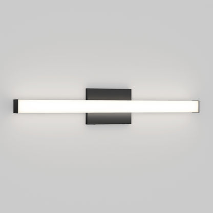 The Mylo LED Vanity Light 24IN is a modern wall-mounted fixture featuring a horizontal rectangular white light bar and a black square base, shown against a plain light gray wall.