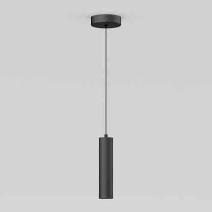 The Damian LED Cylinder Pendant, a minimalist black cylindrical light, hangs from a thin cord attached to a round ceiling mount against a plain white background.