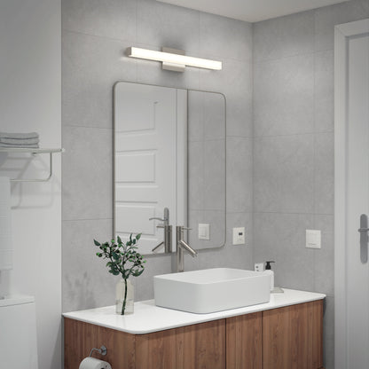 Modern bathroom with gray tiled walls, wooden vanity and white countertop, rectangular vessel sink with brushed metal faucet, large mirror, Mylo LED Vanity Light 24IN above, a small plant, and minimal accessories.