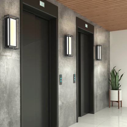 Two modern elevator doors in a hallway with concrete walls, a wooden ceiling, and a potted plant. Ghost Pro Integrated LED Outdoor Wall Lights are mounted on the walls near the elevators.