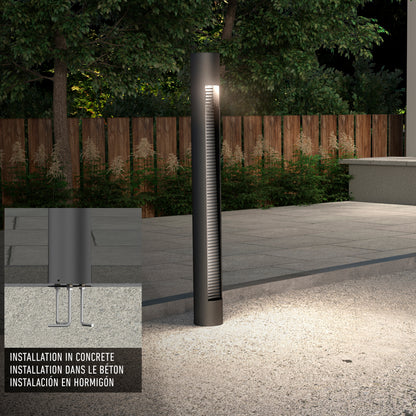 The Dark Sky Pro LED Outdoor Pathway Light Stick is installed in concrete along a path near a wooden fence at night. An inset provides a close-up installation diagram with instructions in English, French, and Spanish.